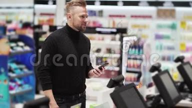 男人在商店里用手机支付购买，非接触式支付技术